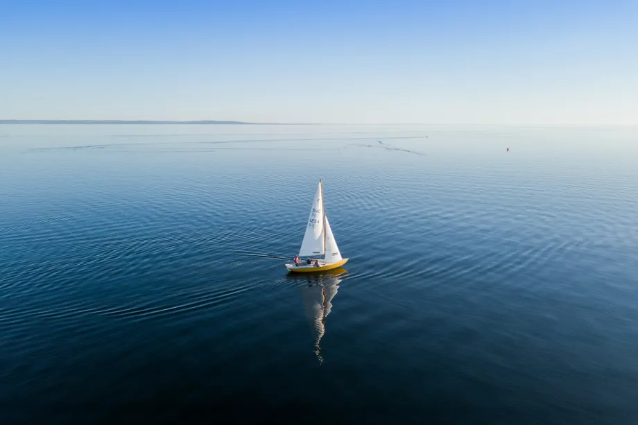 Lone sailing yacht on a wide stretch of open sea